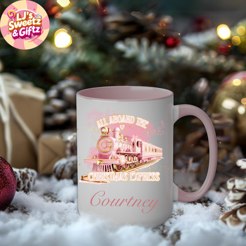 Pink mug with Christmas train design and 'LJ's Sweetz & Giftz' logo in a festive setting.