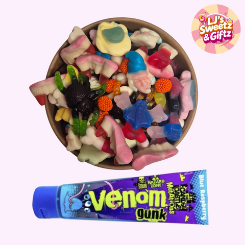 Assorted colorful gummy candies in a bowl with a 'Venom Gunk' package below on a white background.