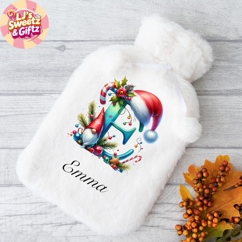 White plush hot water bottle with Christmas-themed design and 'Emma' text, branded 'LJ's Sweetz & Giftz'.