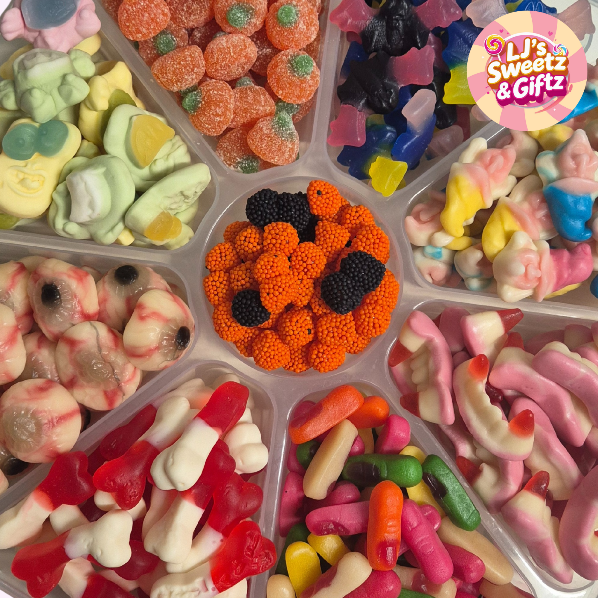 Assorted colorful gummy candies in a display tray with 'LJ's Sweetz & Gifz' branding.