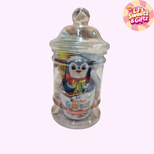 Clear jar with a penguin toy inside, branded 'Kinder Surprise', on a white background with 'LJ's Sweetz & Giftz' logo.
