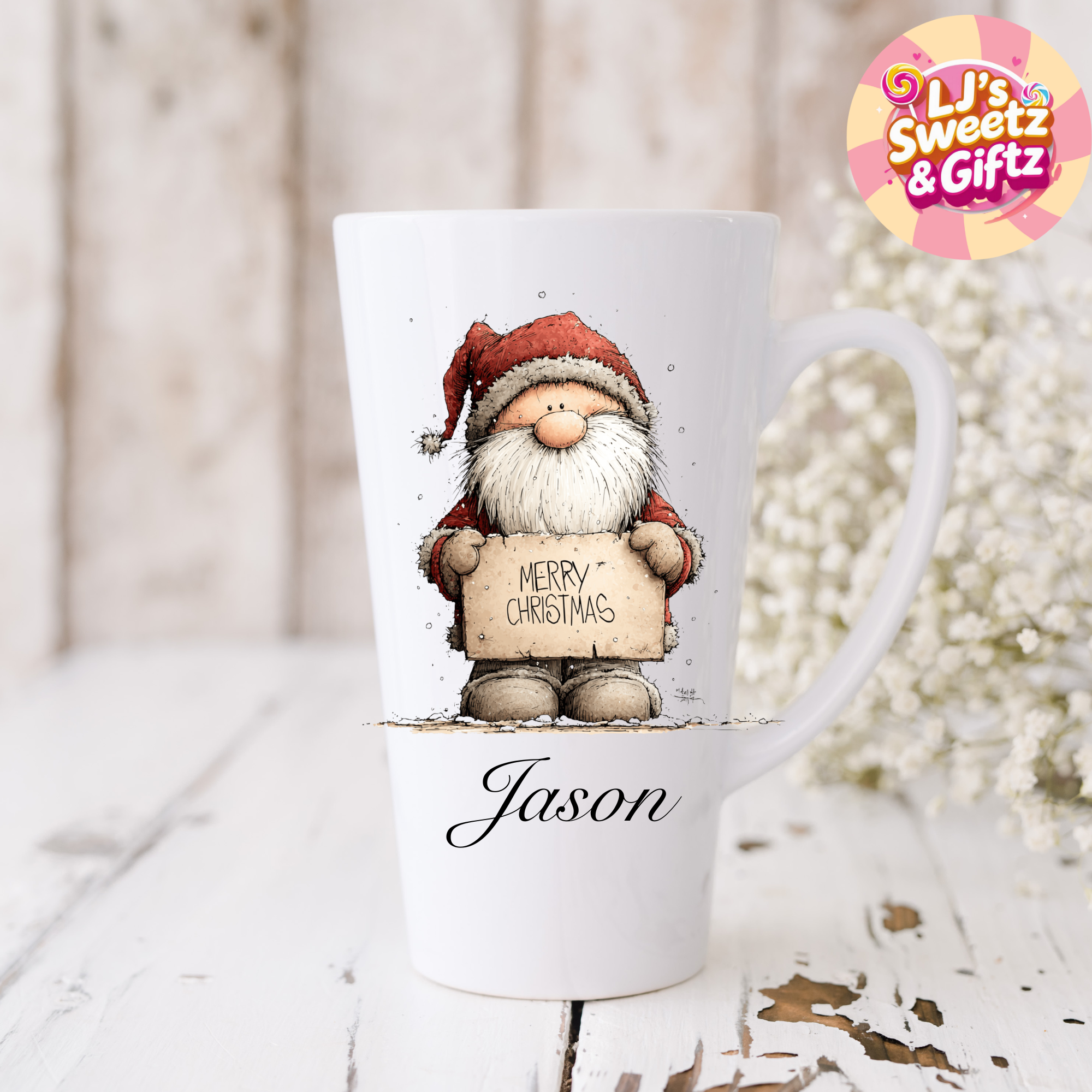 White mug with a Santa Claus design holding a 'Merry Christmas' sign, personalized with 'Jason', on a light wooden surface.