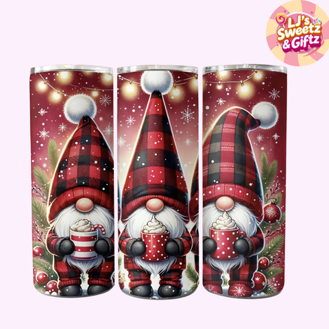 Three Christmas-themed tumblers with gnomes holding hot cocoa, featuring plaid hats and snowflake decorations.