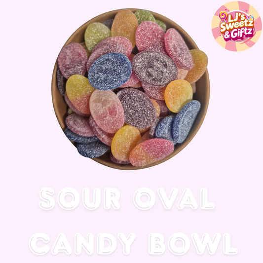 Sour oval candy bowl with colorful candies on a light pink background, branded 'LJ's Sweetz & Giftz'.