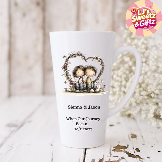 Personalized mug with a design of two people holding hands in a heart shape, surrounded by flowers, on a wooden surface.
