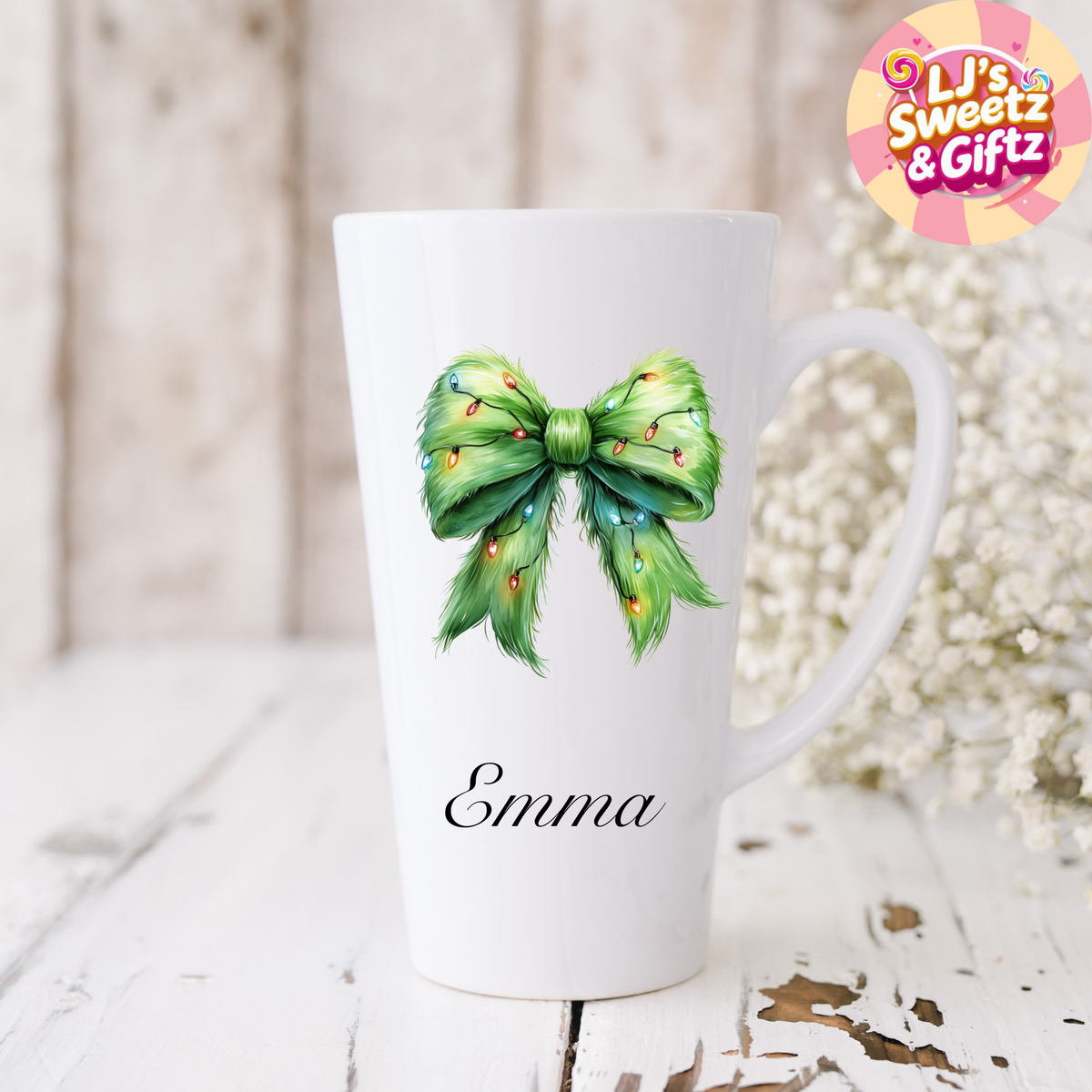 White mug with a green bow design and 'Emma' text, branded with 'Li's Sweetz & Giftz'.